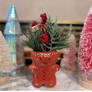 Ceramic Gingerbread Man with festive faux floral decoration.